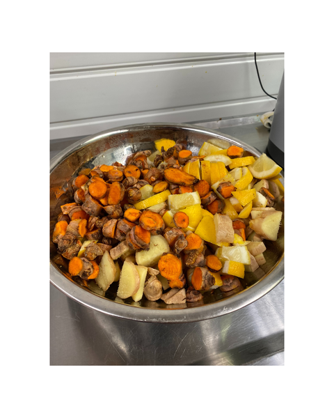 bowl of turmeric ginger and lemon making Spear and arrow juice